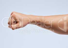 I ought to punch you in the throat. Shot of an unrecognizable man holding his fist up against a white background.