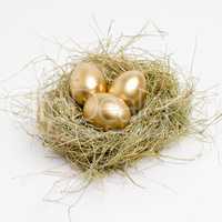 Make sure to save today for a golden nest egg. Studio shot of a clutch of golden eggs laying in a nest.