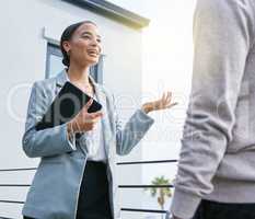 Ill give you a quick tour. Shot of a young female real estate agent showing a client a house.