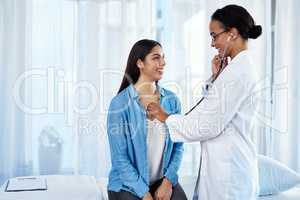 Strong set of lungs you have there. Shot of a young doctor examining her patient with a stethoscope.