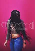 Lifes too short to have boring hair. Shot of a young woman with braids posing against a pink background.