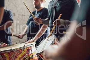 Can you feel the beat. Closeup shot of a musical performer playing drums with his band.