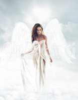 Your guardian angel. Portrait shot of a beautiful angel walking through the heavens.