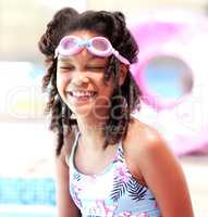 Im always smiling on sunny days. Cropped shot of a young girl wearing swimming goggles and a bathing suit.