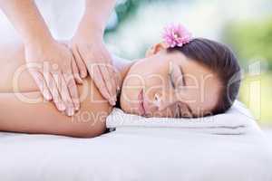 Being pampered. Cropped shot of an attractive young woman enjoying a relaxing massage.