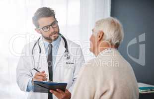 Lets set up an appointment for next week. Cropped shot of a young male doctor going through medical records with his senior male patient.