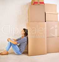 My life stacked high. Shot of an attractive young woman busy moving house.