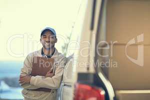 Our service has been rated as the most reliable. Portrait of a delivery man standing next to his van.
