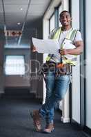 I know exactly how to renovate this space. Shot of a handsome young contractor standing alone in a building and holding the floor plan.