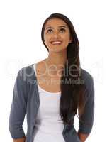 Candid cheerfulness. A beautiful young ethnic woman smiling against a white background.