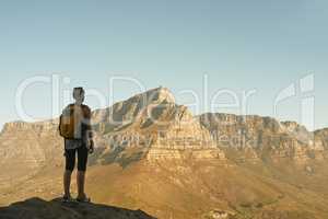 The view is reserved for the victor. Shot of a woman admiring the view from a mountain top.