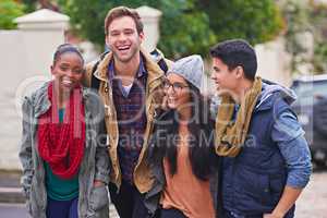 Great times on campus. Shot of a group of happy college students hanging out on campus.