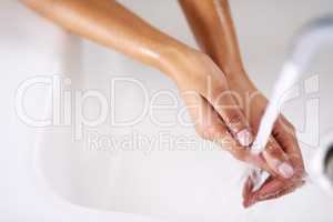 All squeaky clean. Cropped shot of a woman washing her hands at a sink.