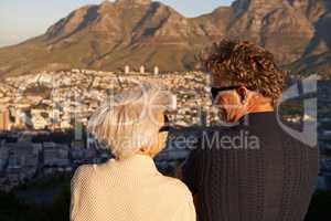 This view was worth the walk. View of a senior couple standing on a hillside together.