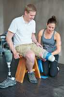 Hes progressing better than she hoped. Shot of a female physiotherapist having a session with a young male amputee.