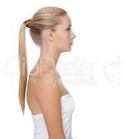 Showing the benefits of great beauty treatments. A beautiful blonde woman with a ponytail isolated against a white background.