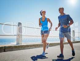 Sharing a healthy relationship. Shot of a young sporty couple out for a run together.