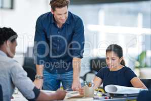 Modern business pros. Shot of a group of young designers working together in an office.