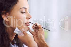 Brining out the best for that special occasion. A young woman having makeup applied.