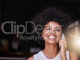 Of course I can reserve that table for you. Shot of a happy young business owner answering her phone while standing inside her coffee shop.