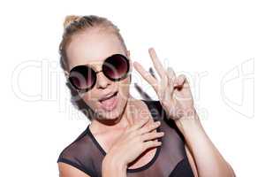 Peace to yall. Portrait of an attractive young woman wearing sunglasses showing the peace sign.