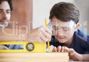 Carpentry is a family profession. A father and son doing woodwork together.