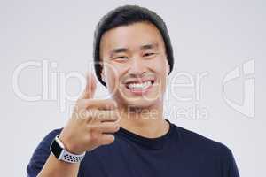 I have to agree. Studio portrait of a handsome young man giving a thumbs up against a grey background.