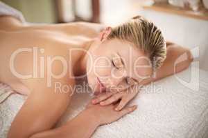 Whole body relaxation. Shot of a young woman lying on a massage table at the spa.