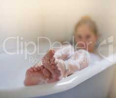 Let all your worries just drift away. Shot of a beautiful young woman relaxing in the bathtub.