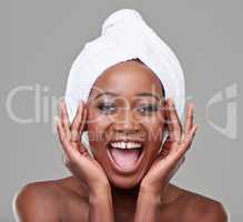 Ecstatic and lovely. Studio portrait of a young woman with beautiful skin being cheerful.