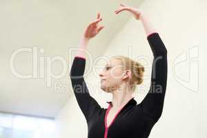 Her fifth position is flawless. Shot of a young woman practising ballet.