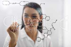 Marvels of mankinds genius. Cropped shot of a female scientist drawing up a molecule.