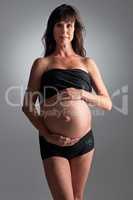Expecting her arrival soon. A pregnant woman holding her tummy.