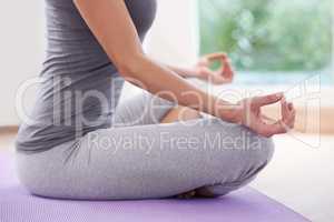 Serenity through yoga. A cropped image of a woman sitting crossed legged and meditating.