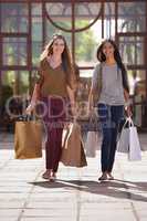 Retail Therapy. Two attractive young woman with their shopping bags after a day of retail therapy.