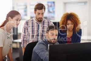 They share a collective vision aimed at success. Cropped shot of a group of colleagues working together in an office.