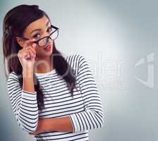 Explain yourself. Shot of a young woman posing against a grey background.