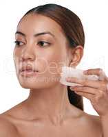 You gotta work for that natural glow. Shot of a beautiful woman using a Gua Sha tool on her face.