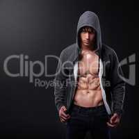Strength above all else. Studio shot of a handsome bare-chested young athlete standing against a black background.