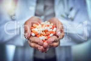 Get the treatment you need. Closeup shot of an unidentifiable doctor holding a variety of pills in her hands.