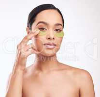 Good skin care helps your skin stay in good condition. Studio shot of a beautiful young woman wearing a gel eye mask while standing against a white background.