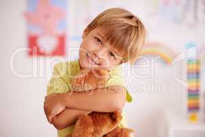 Childhood moments. Portrait of a cute little boy hugging his stuffed animal.