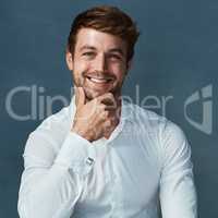 Hes got charm and confidence. Studio portrait of a handsome young man posing against a dark background.