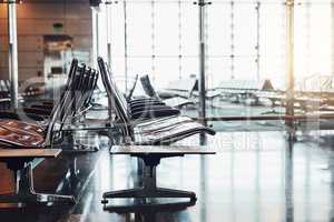 Where people form different places come together. Shot of rows of seats in an empty airport departure lounge.