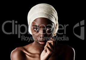 The perfect portrait of beauty. Studio portrait of a beautiful woman wearing a headscarf against a black background.