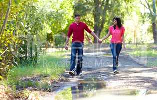 Taking a romantic stroll. Shot of an affectionate young couple going for a walk outdoors.