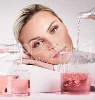 When I think of the most beautiful women, theyre not supermodels. Studio shot of young woman making a potion against a white background.