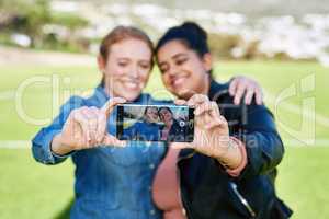 We have to capture our friendship together. Shot of female friends taking a picture together outside.