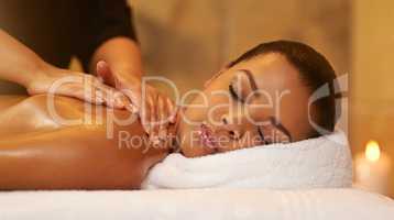 Healing hands. Cropped shot of a young woman getting a massage at the spa.