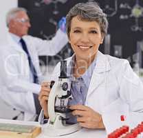 Shes a respected member of the faculty. Shot of a mature female scientist working in a lab.